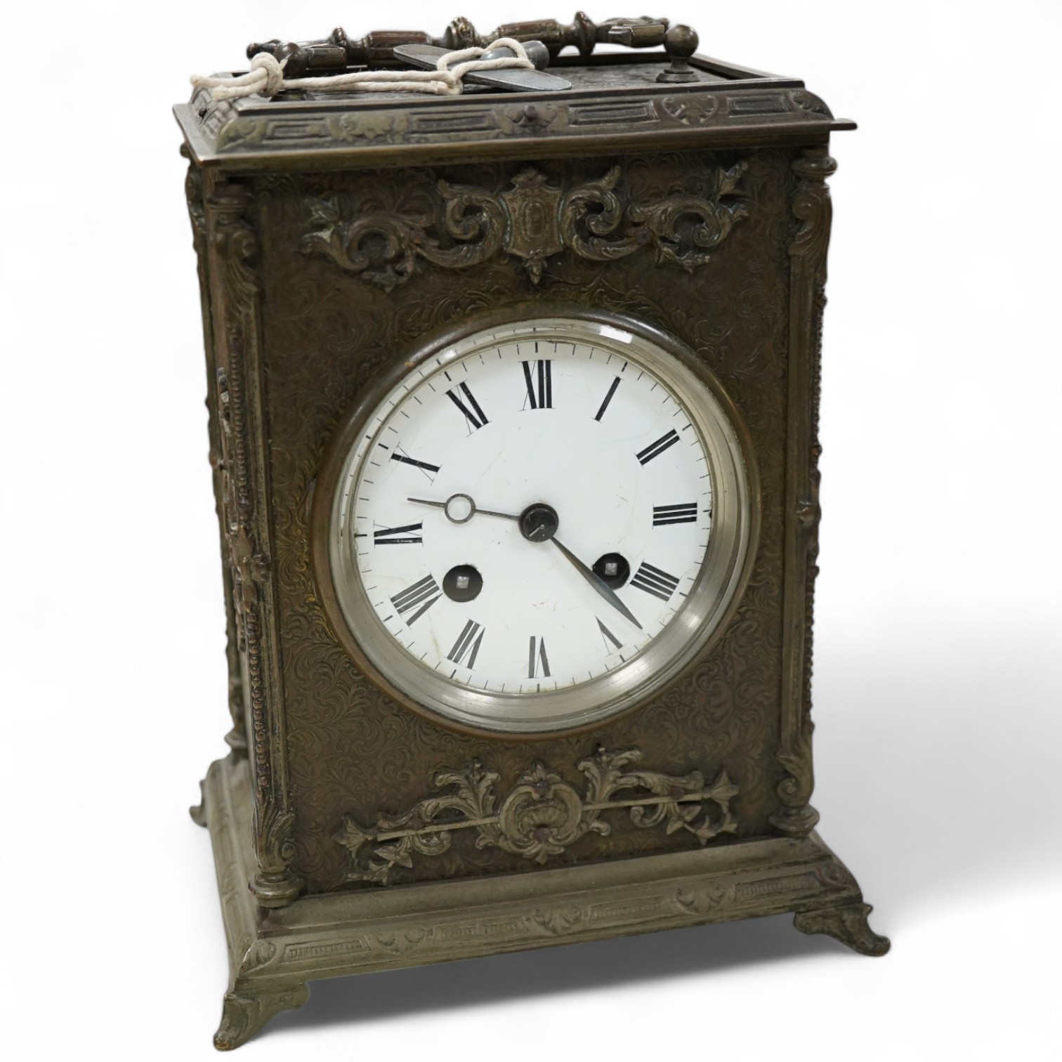 A brass overlaid mantel clock with key and pendulum, striking on a bell, 26cm high